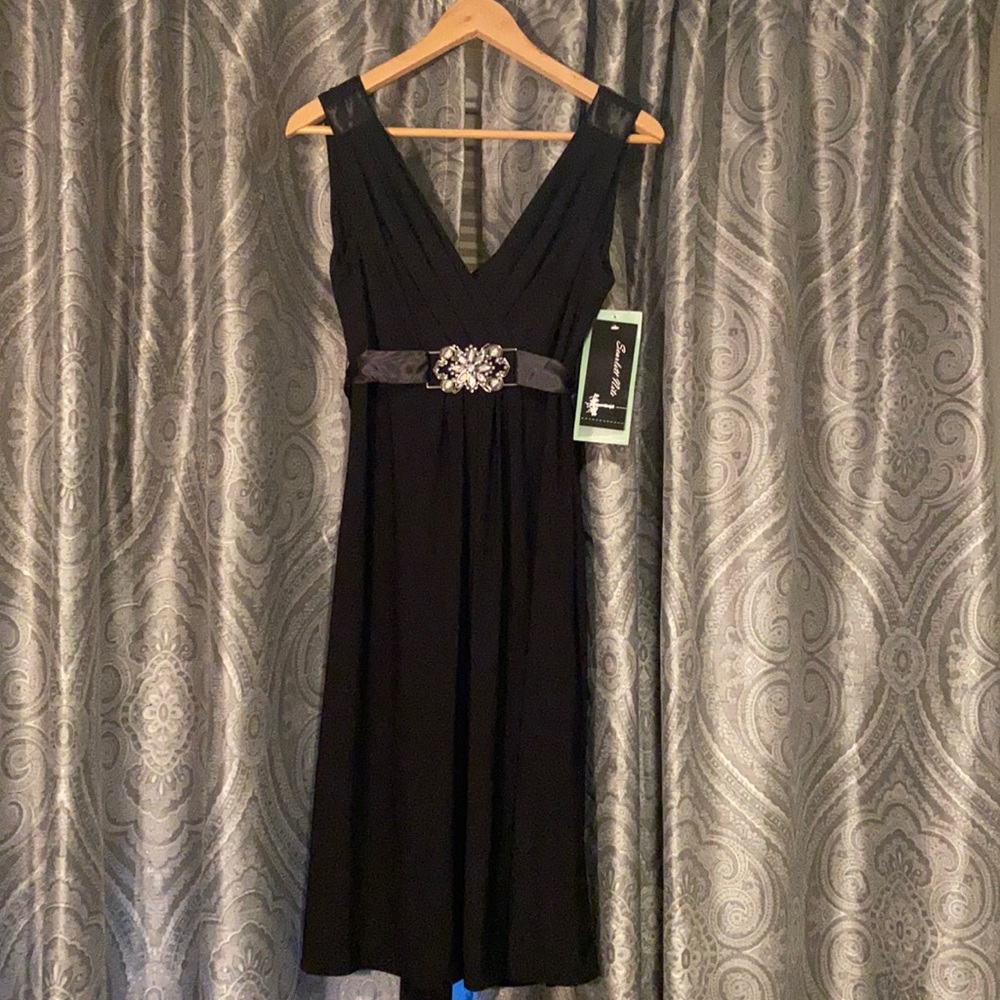 New with tags!  Beautiful classic black dress.
